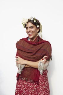 Stylish woman wearing shawl and flowers in hair