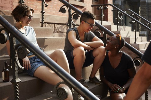 Friends relaxing on front stoop