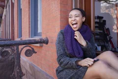 African American woman laughing in window
