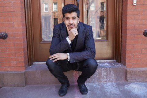 Middle Eastern man sitting on front stoop