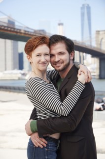 Caucasian couple hugging at waterfront