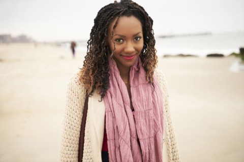 Black woman smiling on beach