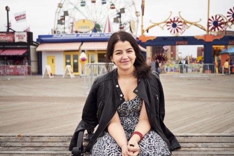 Mixed Race woman sitting on bench at amusement park