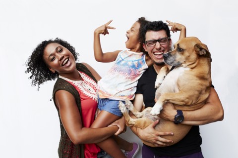Man and woman holding daughter and dog