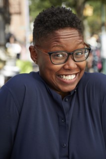 Portrait of Black woman shrugging on city sidewalk