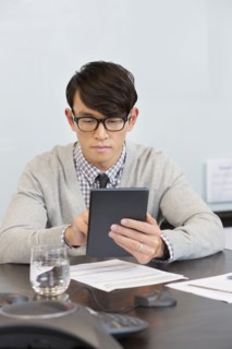 Korean businessman using digital tablet in office