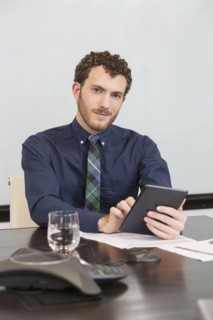 Caucasian businessman using digital tablet in office