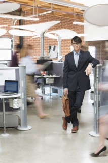 Businessman standing in busy office