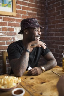 African American man laughing in restaurant
