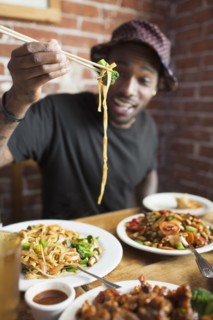 African American man eating at restaurant