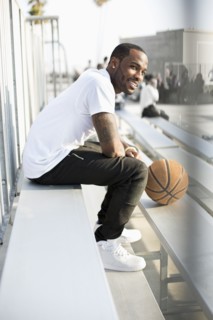 African American man sitting in bleachers