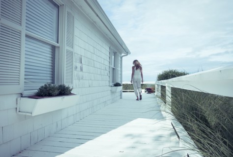 Caucasian woman walking on porch