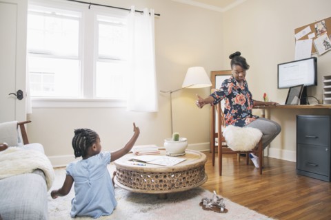 African American mother and daughter gesturing thumbs up