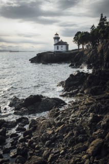 Distant lighthouse on rocky beach
