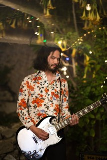 Man with beard playing guitar