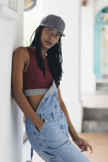 Casual Mixed Race woman leaning on wall