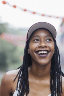 Smiling Mixed Race woman looking away