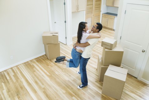 Asian couple hugging in new house