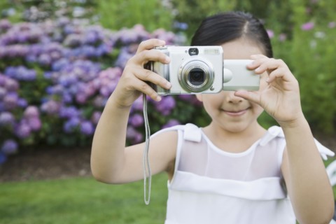 Mixed Race girl taking photograph