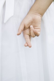 Mixed Race girl with fingers crossed