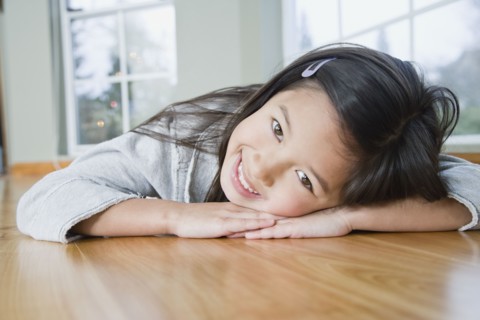 Mixed Race girl resting head on hands