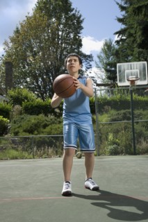 Asian boy playing basketball