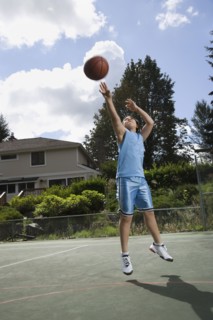 Asian boy playing basketball
