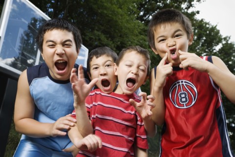 Asian brothers yelling on basketball court