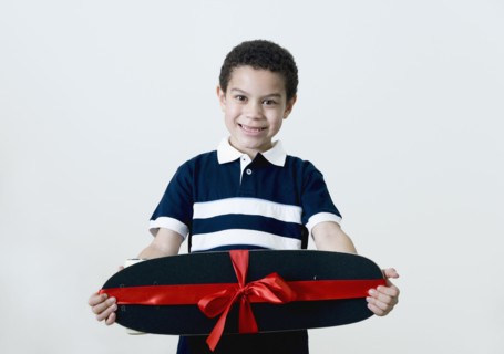 Mixed race boy holding skateboard