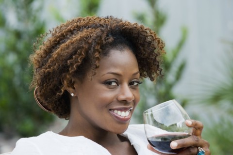 African woman drinking red wine