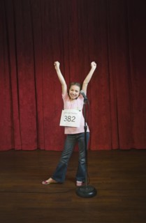 Mixed race girl competing in spelling bee