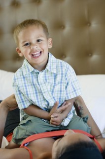 Mother and son playing on bed