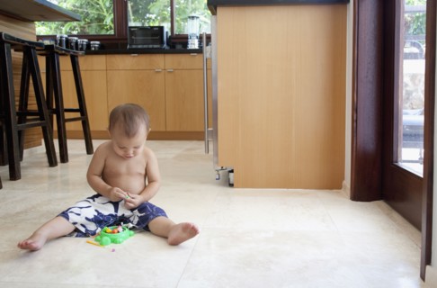 Mixed race boy playing with toys on floor