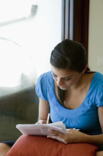 Mixed race woman filling out forms
