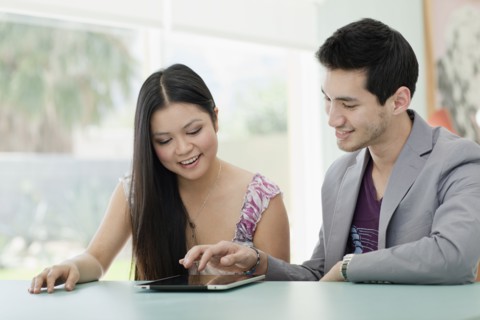 Couple using digital tablet together