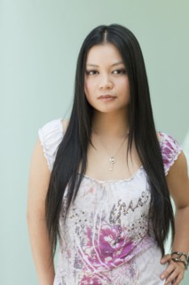 Serious Vietnamese woman with hands on hips