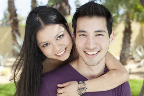 Smiling woman hugging husband