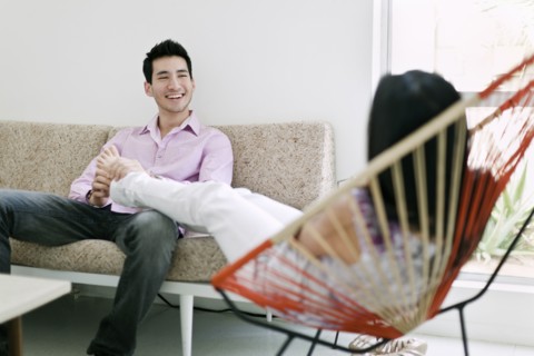 Husband rubbing wife's feet in living room