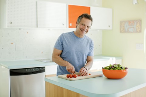 Man cutting vegetables in kitchen