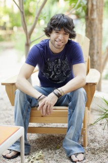 Mixed race man sitting in Adirondack chair