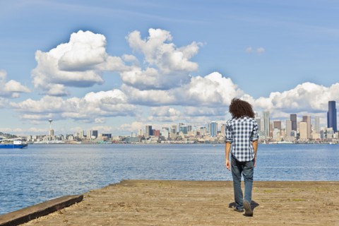 Mixed race teenager standing at urban waterfront