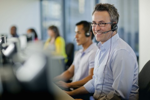 Business people working on computers in call center