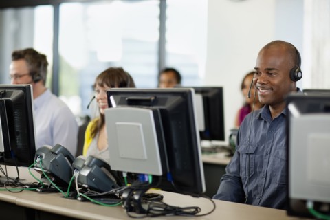 Business people working on computers in call center