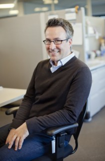 Caucasian businessman sitting at desk in cubicle