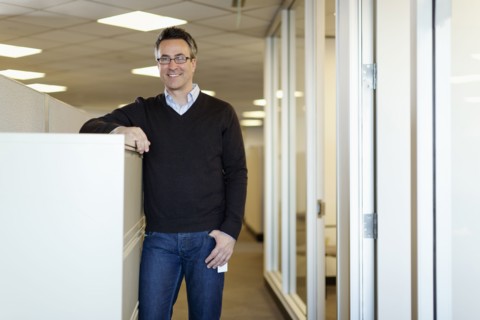 Smiling Caucasian businessman standing in office