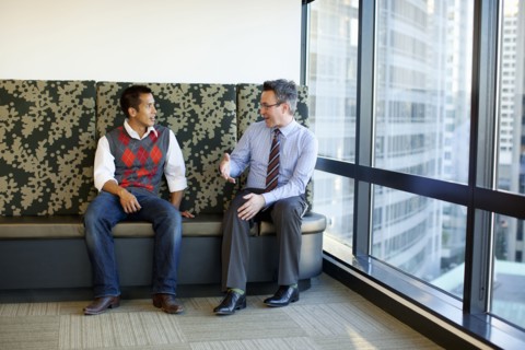 Businessmen talking together in office lobby