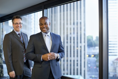 Smiling businessmen standing in office