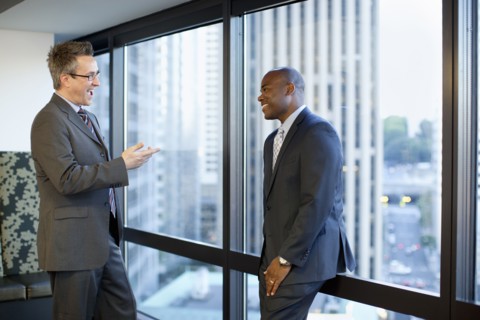 Businessmen talking together in office