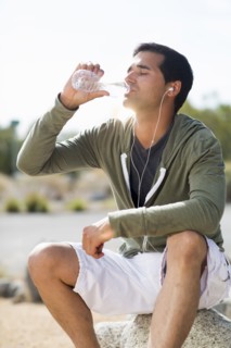 Mixed race man drinking water after exercise