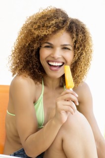 Mixed race woman eating popsicle